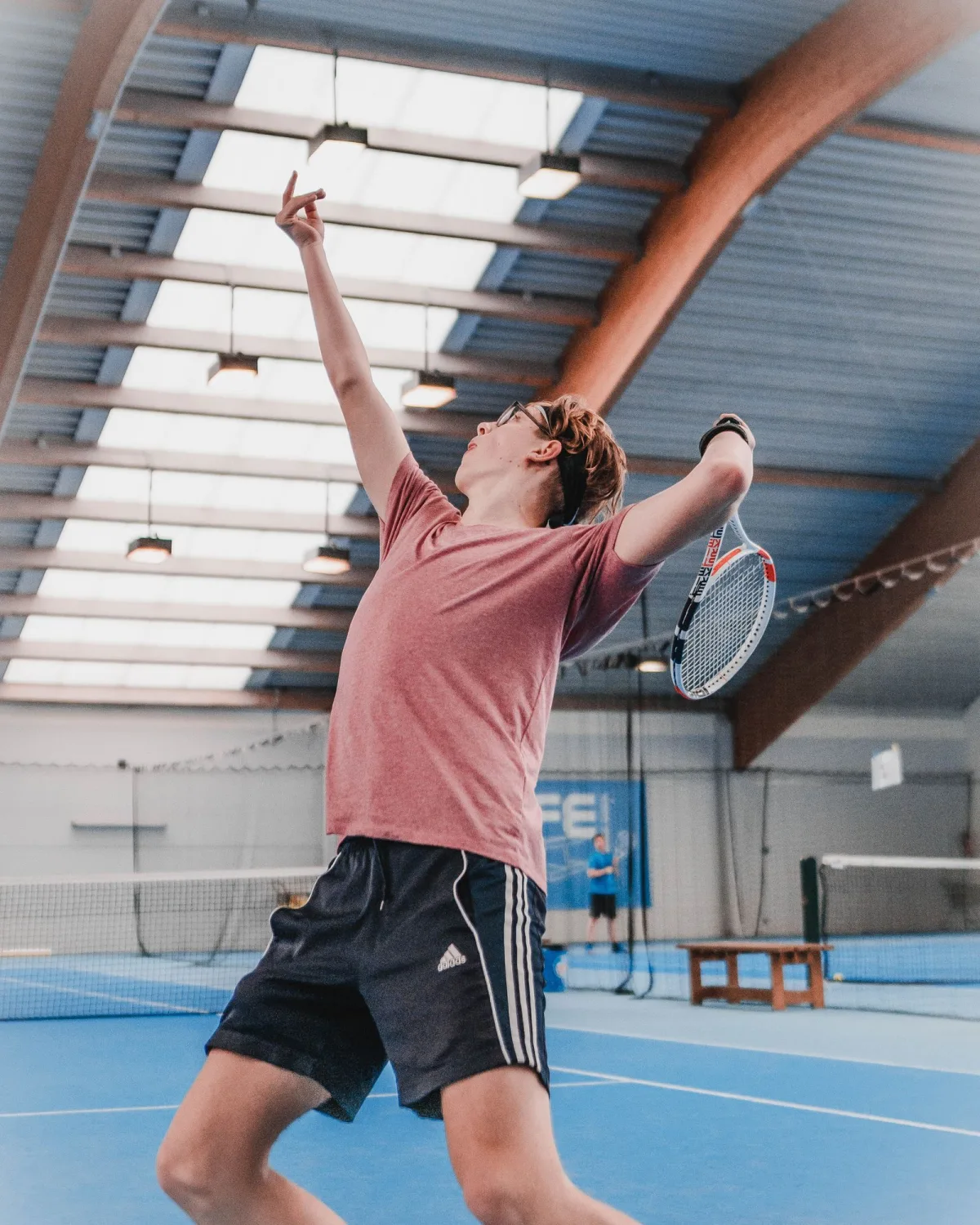 A tennis player preparing to strike the ball on an outdoor court